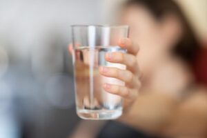 woman holding water before exercising and taking semaglutide
